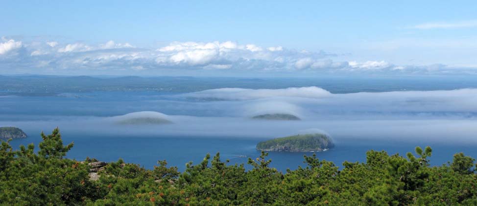 Fog rolling across islands, seen from the summit of Dorr Mountain (photo by Mark Malnati)