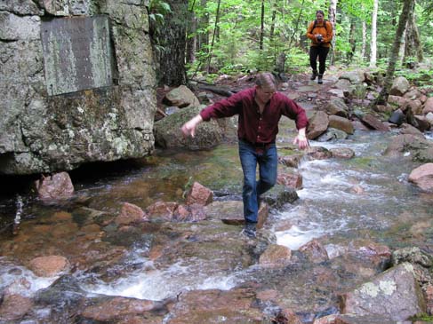 Tom crossing the brook on submerged rocks (photo by Mark Malnati)